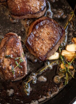 venison soaked in buttermilk in a cast iron pan