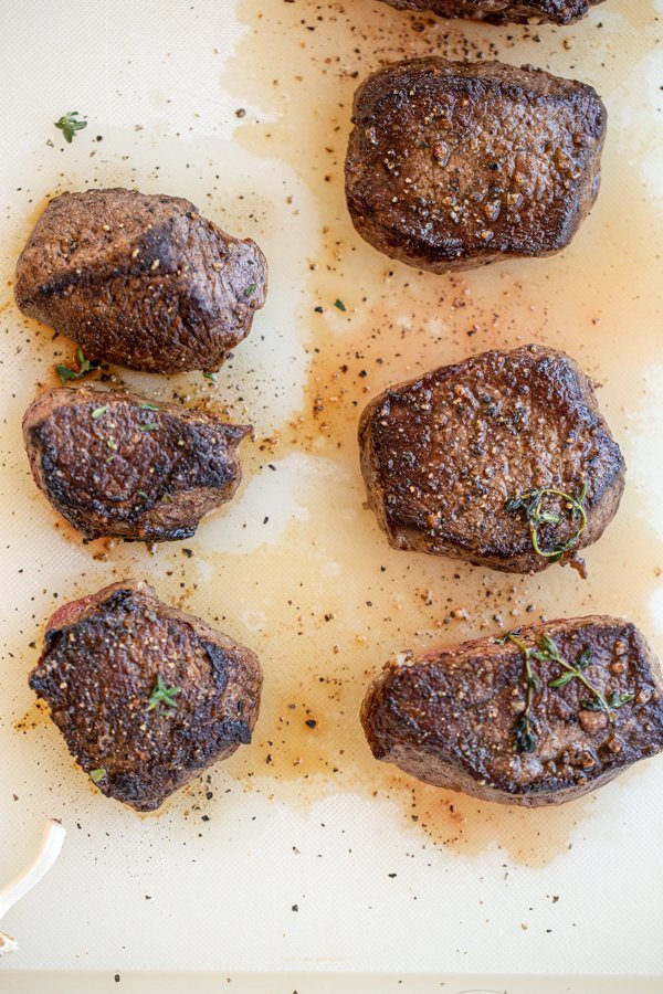 venison soaked in buttermilk on a cutting board after cooking