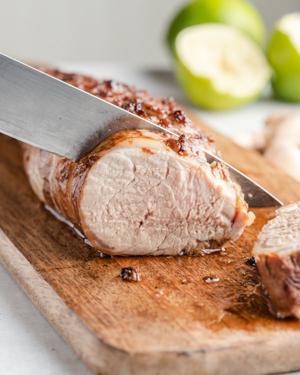 honey garlic pork tenderloin on a wood cutting board