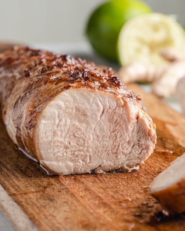 honey garlic pork tenderloin on a wood cutting board