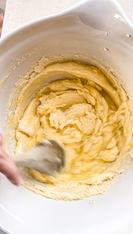 butter, sugar and eggs being mixed in a bowl