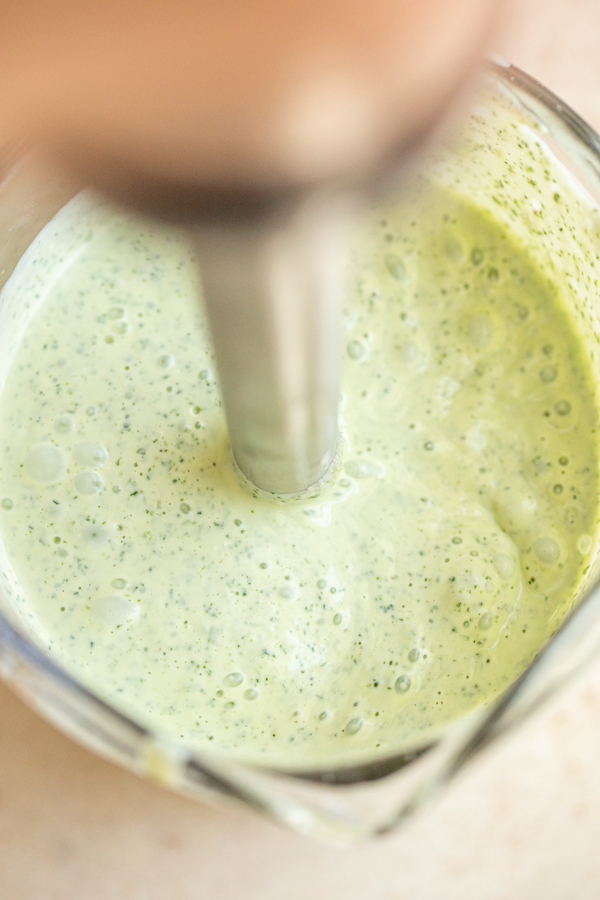 creamy garlic and herb sauce being blended