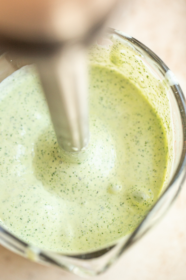 creamy garlic and herb sauce being blended