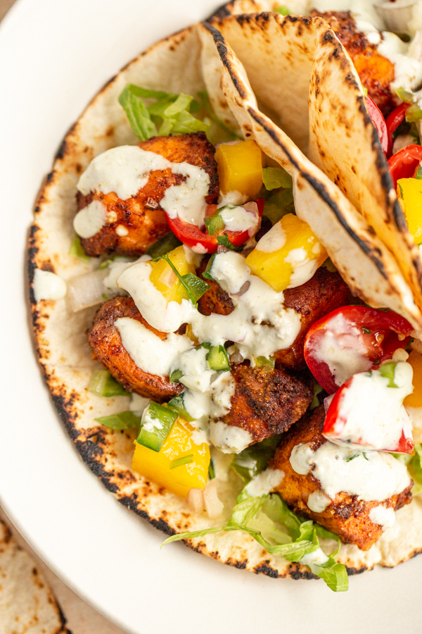 air fryer salmon tacos on a plate in a tortilla