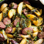 potatoes, sausage, kale and onion in a cast iron skillet