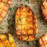 scored potato halves with crosshatch cuts roasted in the oven until crispy