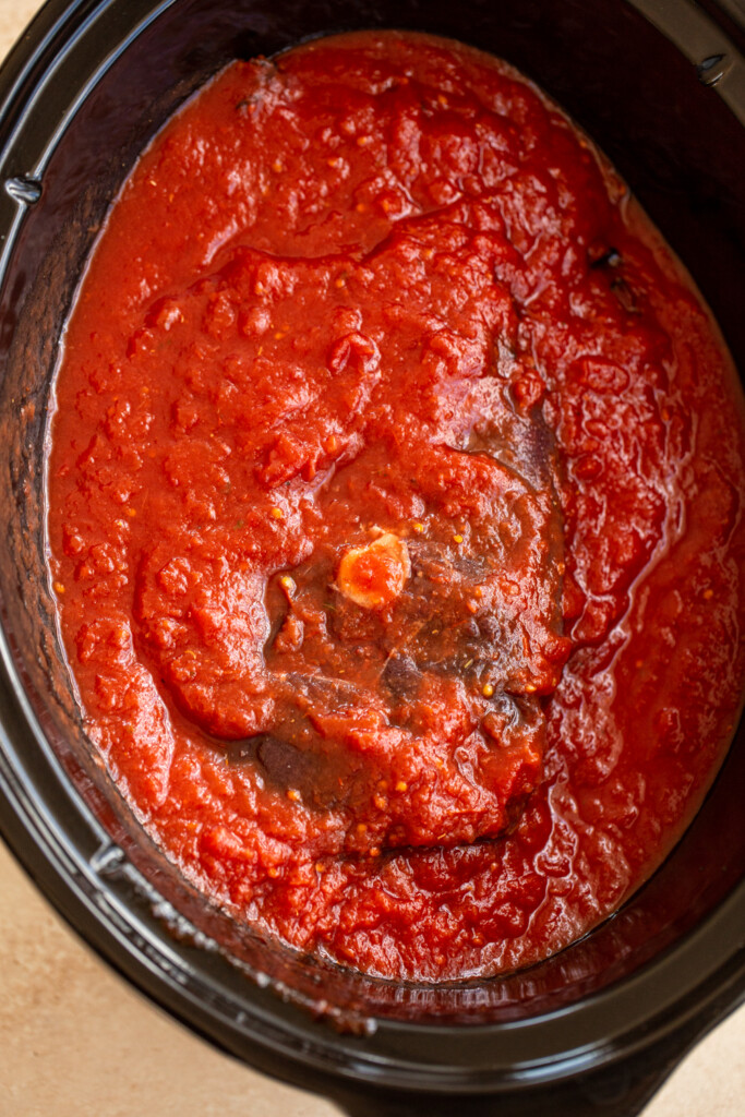 venison roast in tomato sauce in a slow cooker