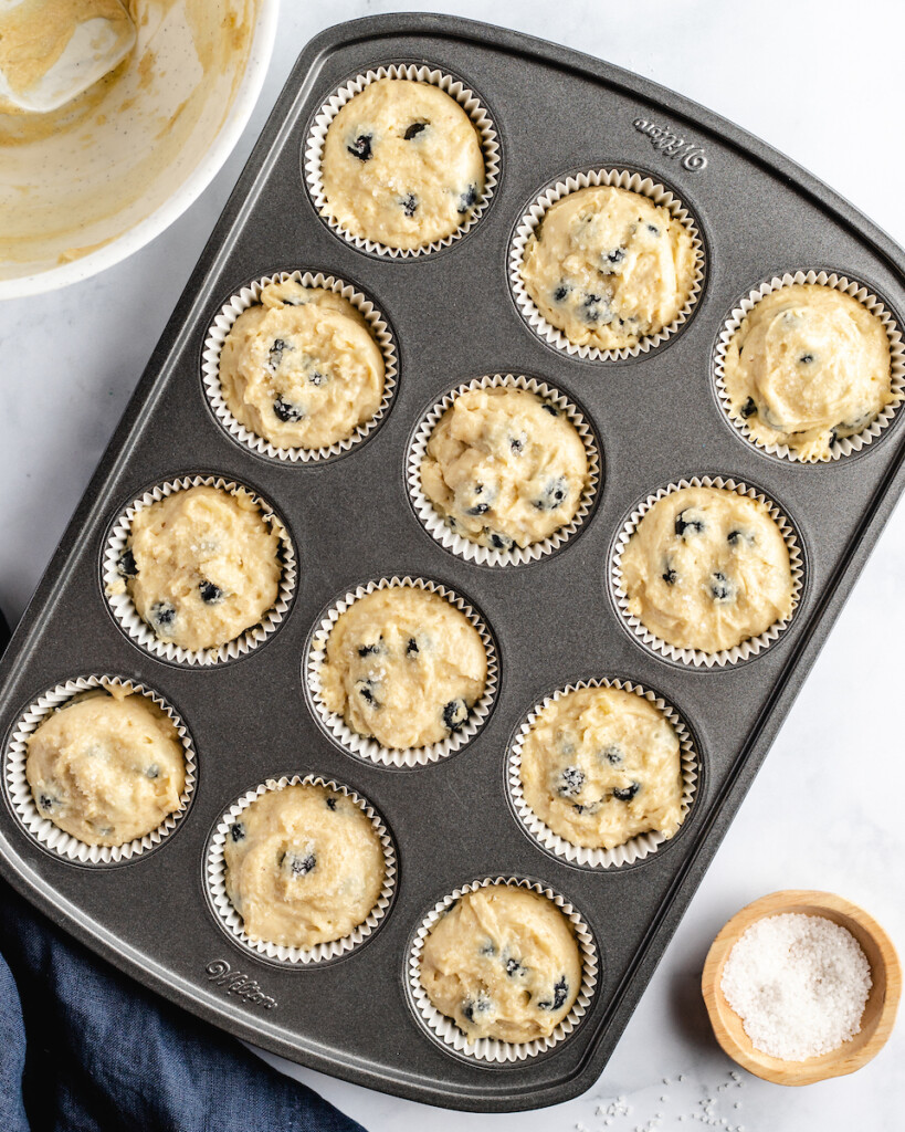 unbaked blueberry muffins in a muffin tin