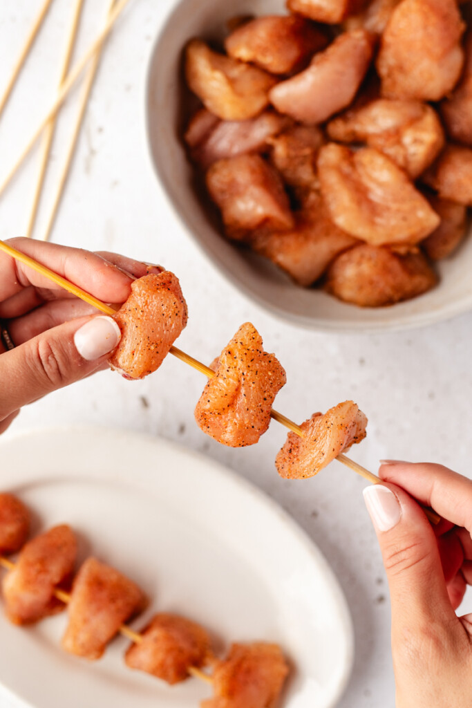 Honey Mustard Chicken Kebabs being assembled on wooden skewers