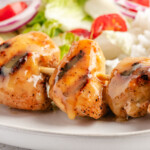 Honey Mustard Sauce dripping off a grilled chicken kebab on white plate