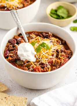 Chili in white bowl with toppings