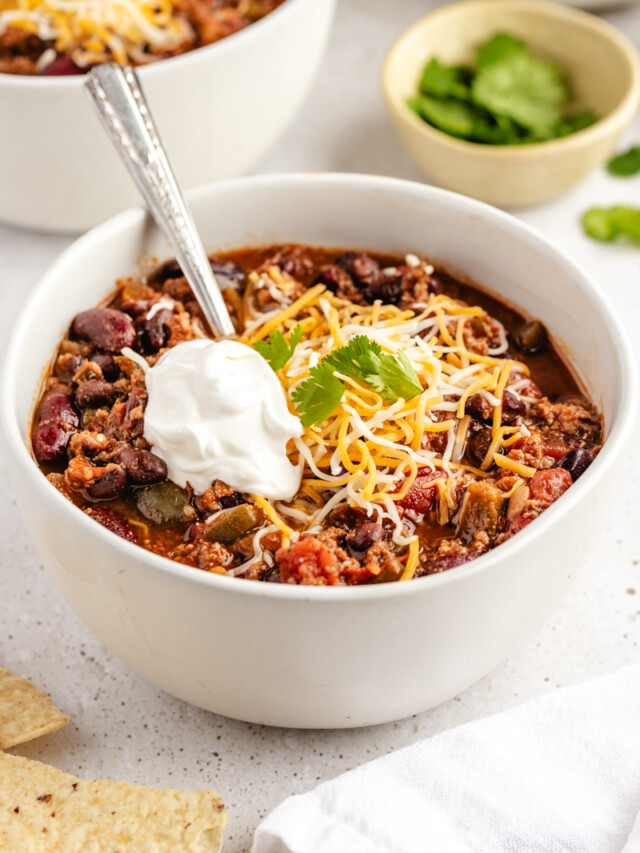 Chili in white bowl with toppings