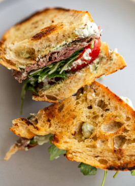 Venison steak sandwich on a blue plate