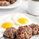 Venison Breakfast Sausage patties on white plate with eggs