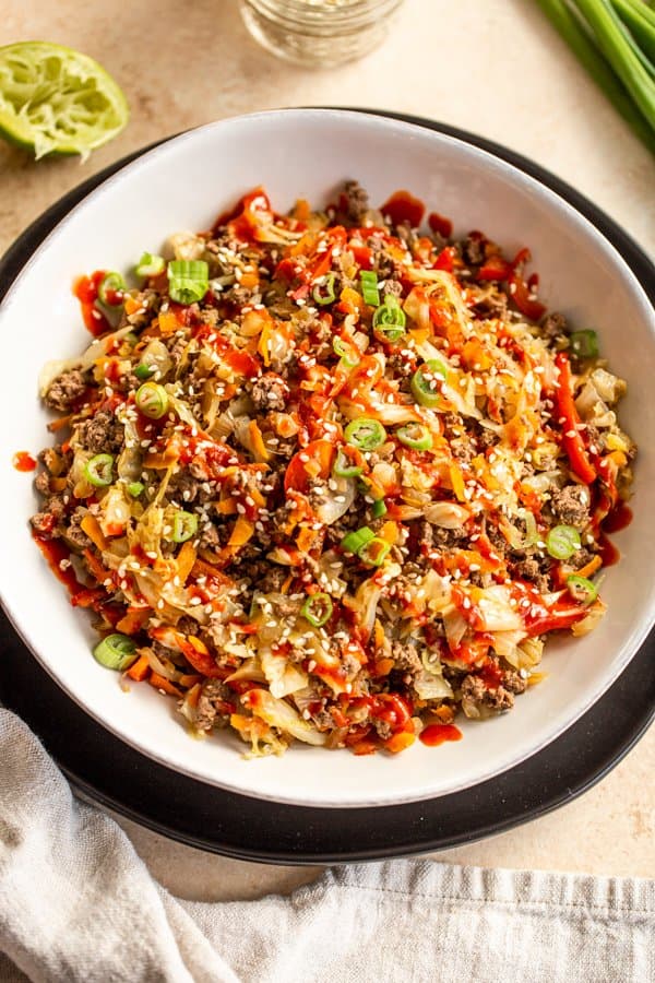 venison egg roll in a bowl in a white bowl on a black plate