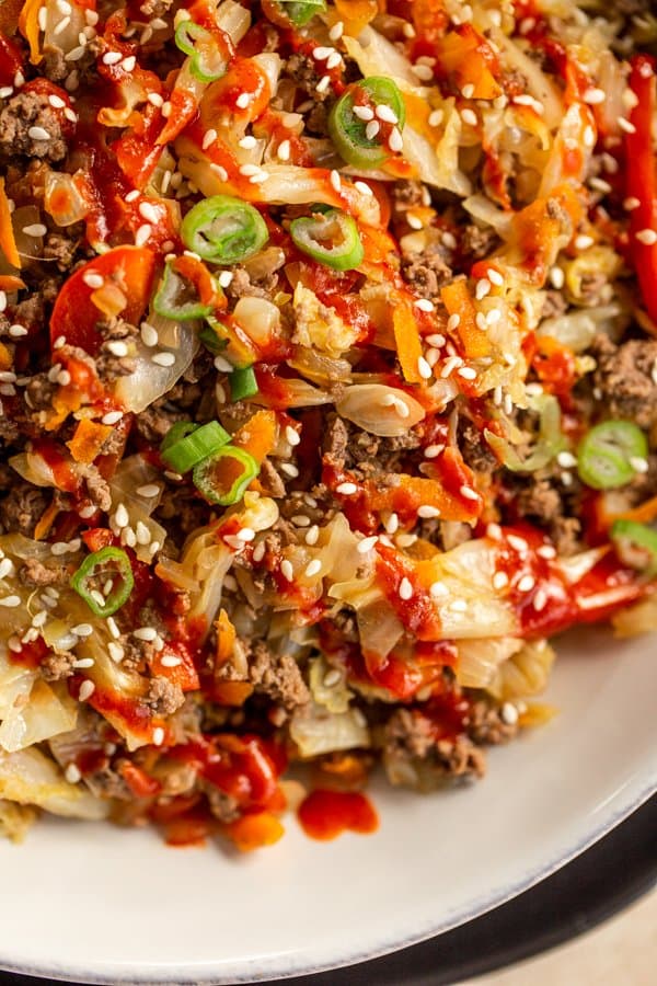 venison egg roll in a bowl in a white bowl on a black plate