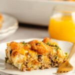 A slice of Venison Breakfast Casserole on a white plate with a fork