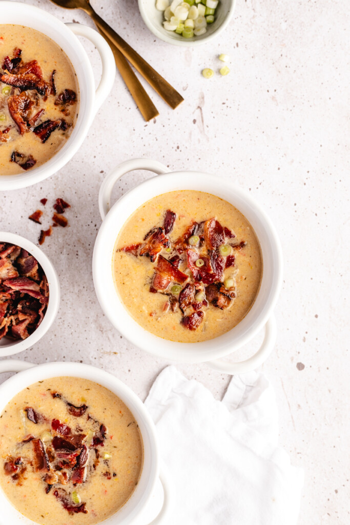 Chicken Corn Chowder in white bowls garnished with bacon and green onions