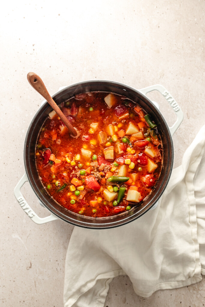 Hamburger soup cooking in white soup pot