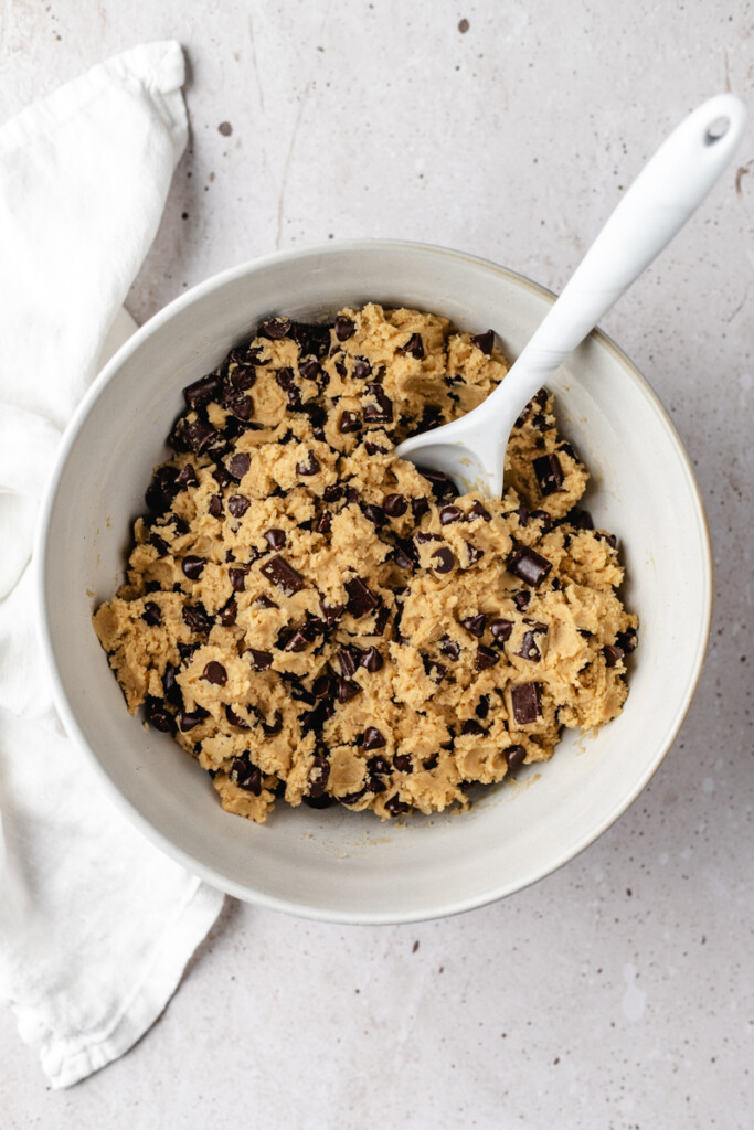 Brown Butter Chocolate Chip Cookie dough in a white mixing bowl