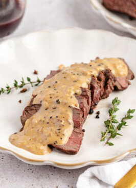 Venison Au Poivre served on a white plate