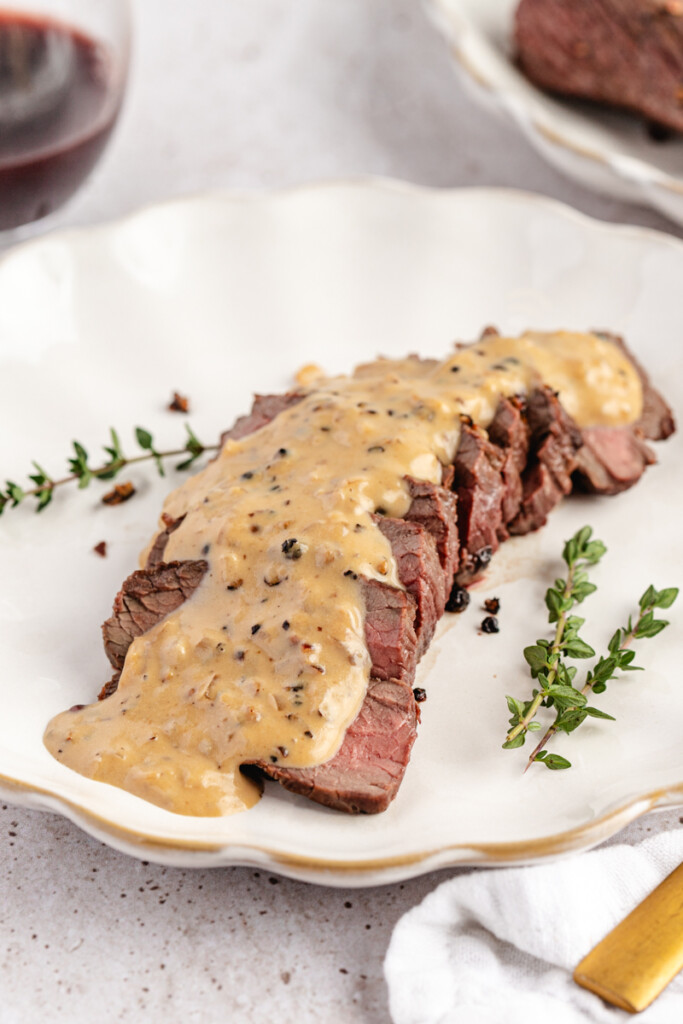 Venison Au Poivre served on a white plate
