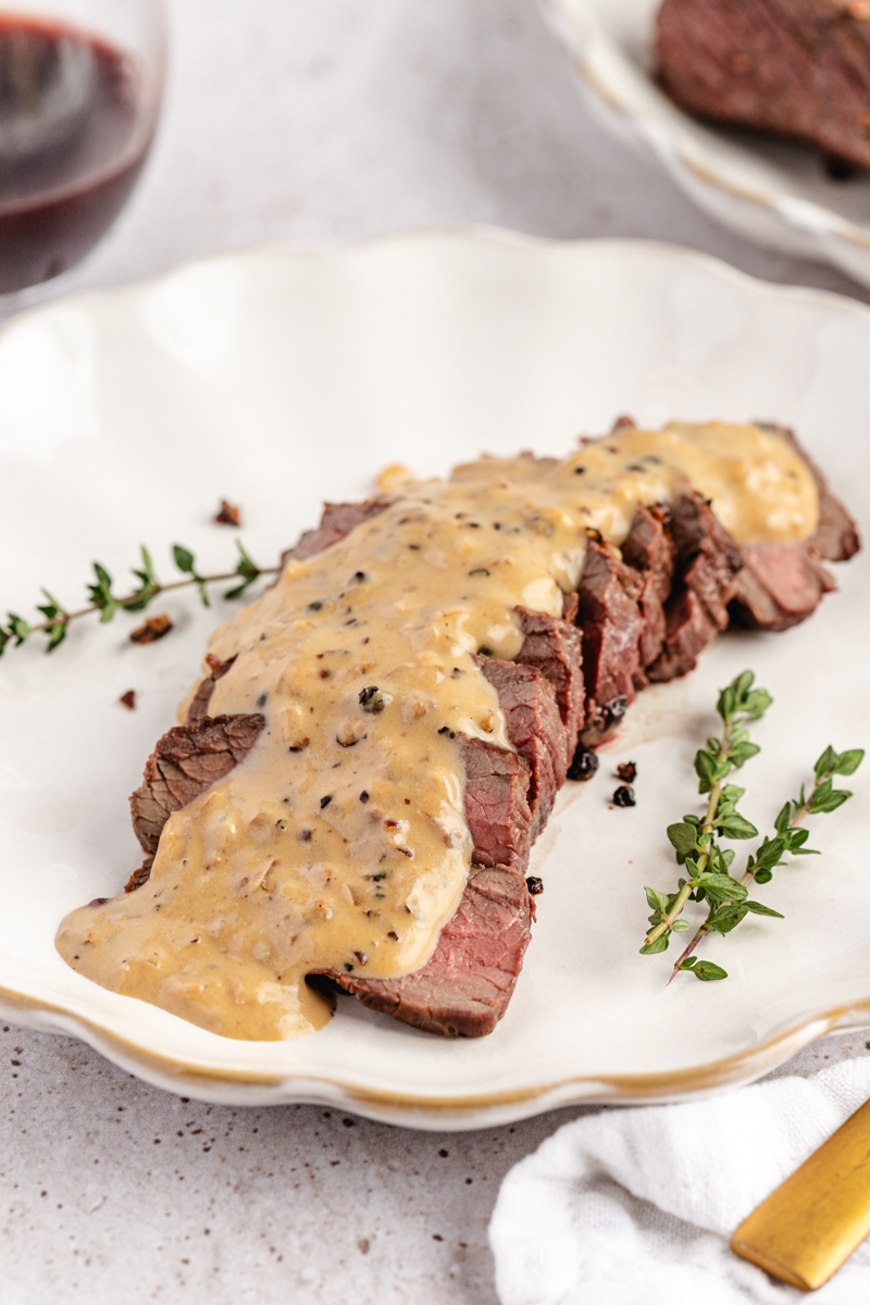 Venison Au Poivre served on a white plate