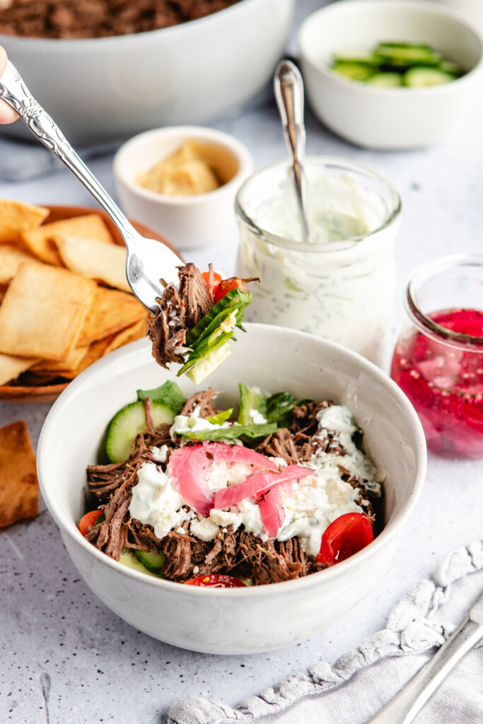 A fork taking a bite out of a Greek Venison Power Bowl