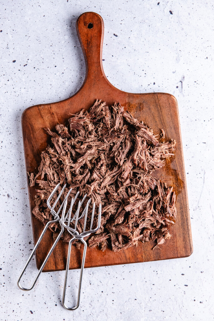 Venison roast shredded on a cutting board