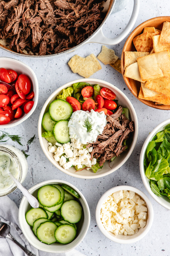 Greek Venison Power Bowl being assembled in a white bowl