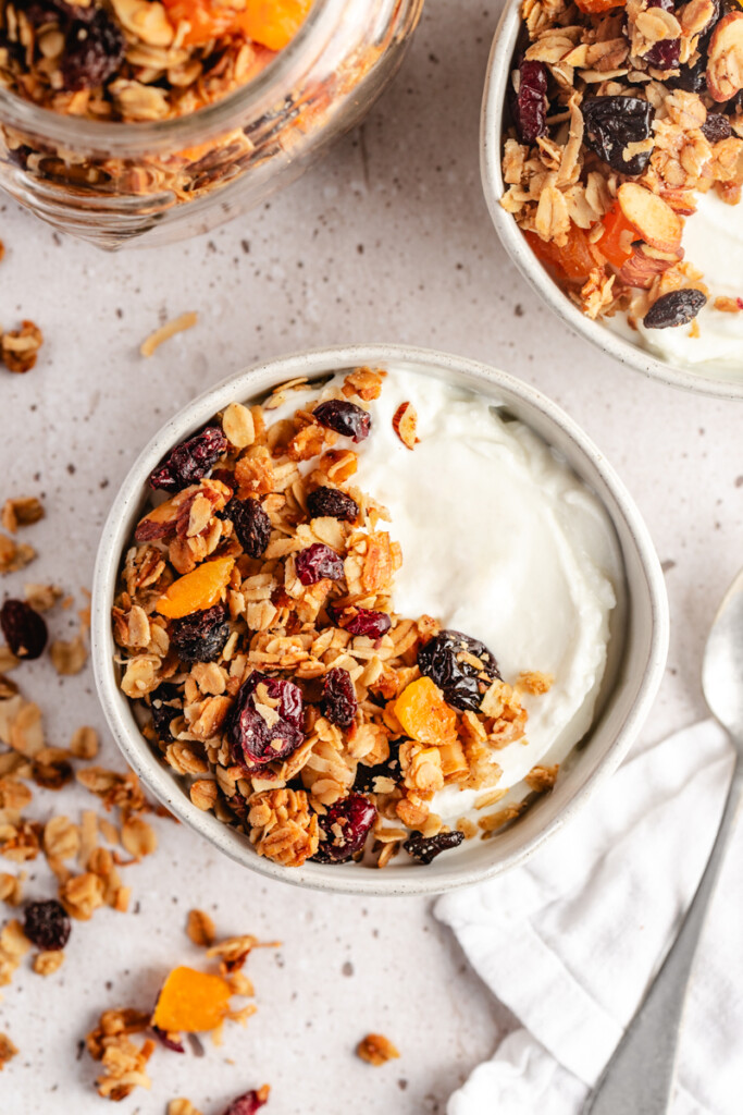 Yogurt and granola in a white bowl