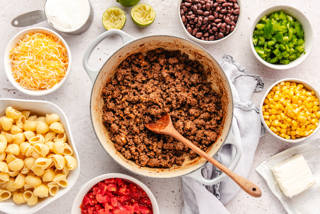 ingredients for a pasta bake on a white background