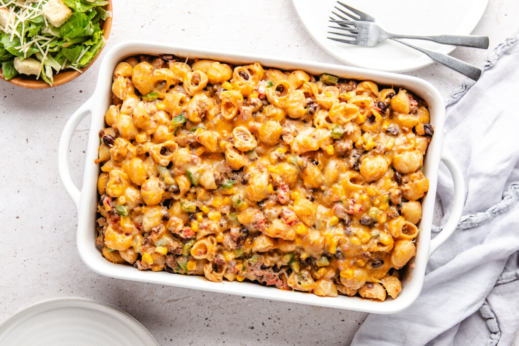 venison cheesy pasta bake in a white casserole dish