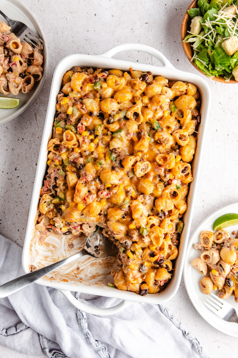 southwest cheesy pasta bake in a white casserole dish