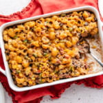 cheesy pasta bake in a white casserole dish